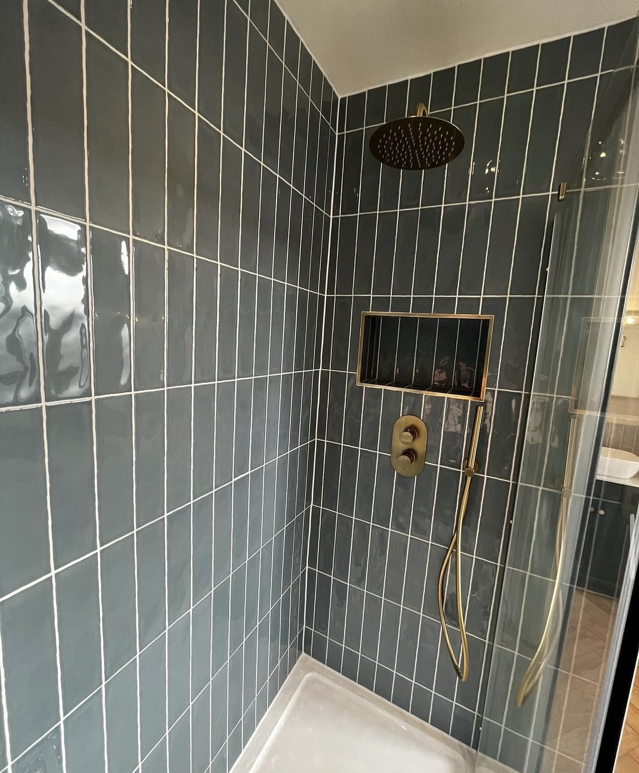 Local plumber from M3 Trades installing brushed brass bathroom fittings