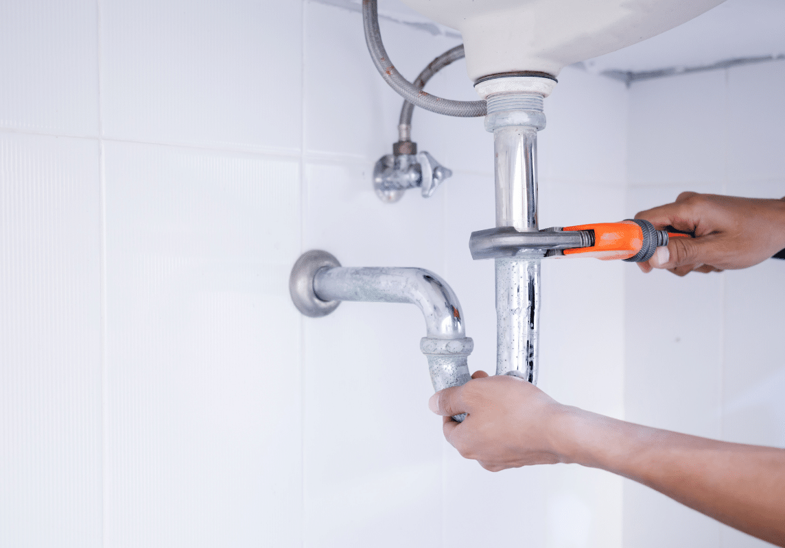 An M3 Trades plumber carrying out plumbing services in a bathroom